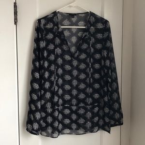 Sheer blue patterned, long-sleeved shirt.